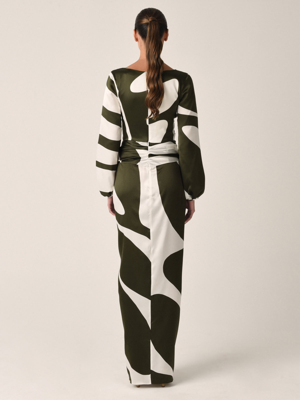 A black and white striped long-sleeve crop top with a central ring detail and drawstring ties at the bottom, offering an Odette Blouse Green Abstract-inspired look perfect for any occasion.