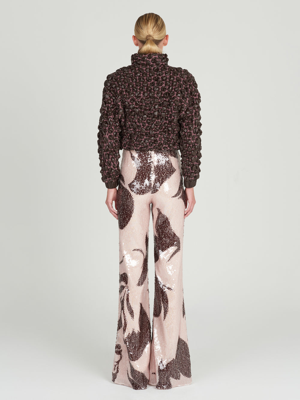 This brown and pink Zalta Jacket Brown features ruffles, perfect for adding a feminine touch to any outfit.