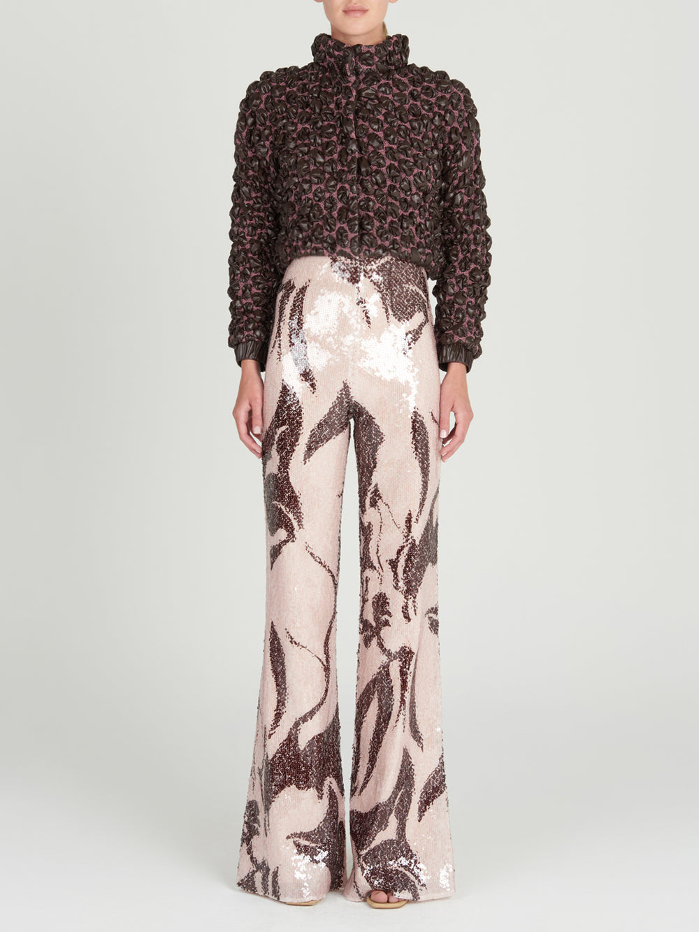 This brown and pink Zalta Jacket Brown features ruffles, perfect for adding a feminine touch to any outfit.