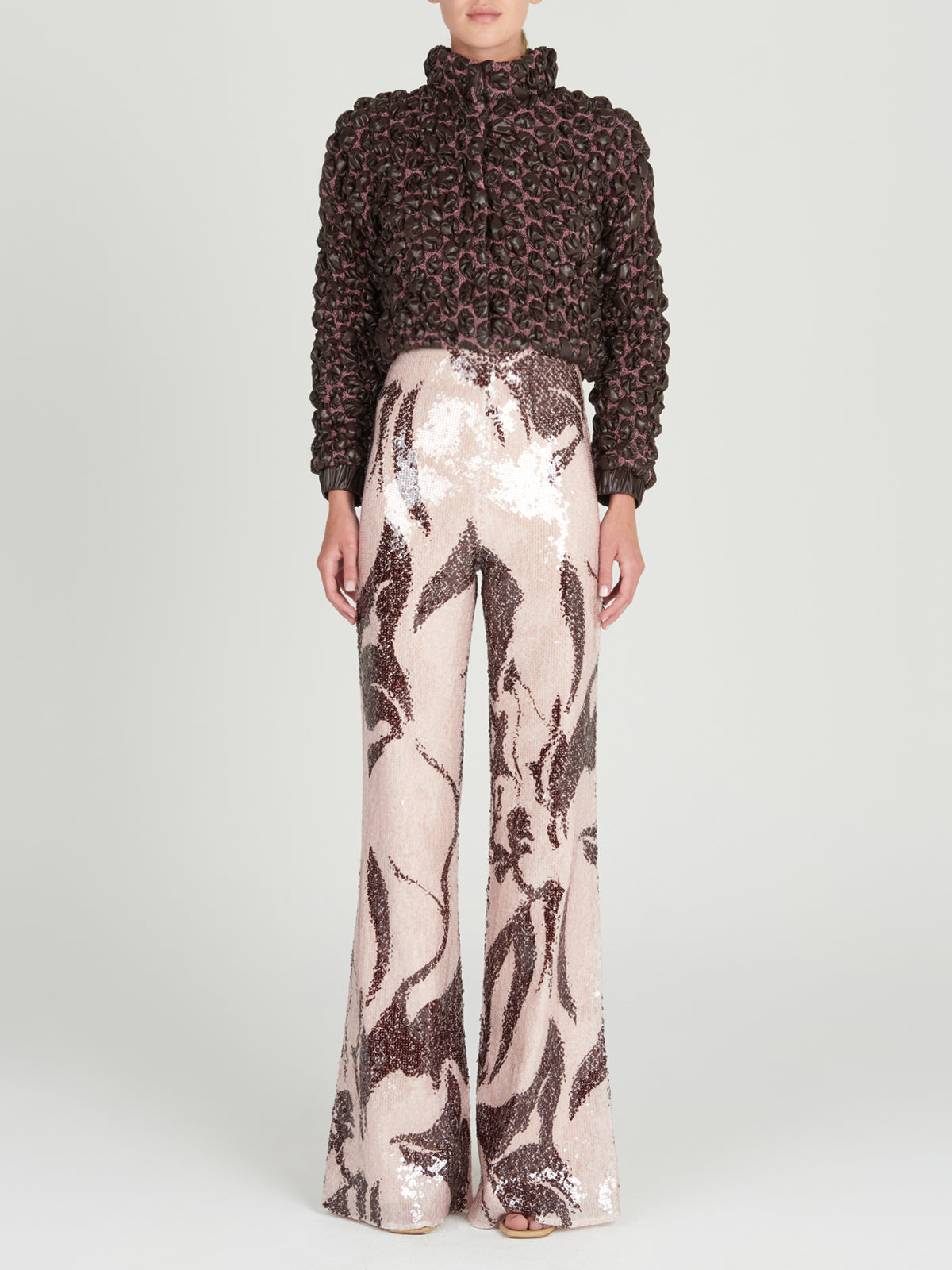 This brown and pink Zalta Jacket Brown features ruffles, perfect for adding a feminine touch to any outfit.