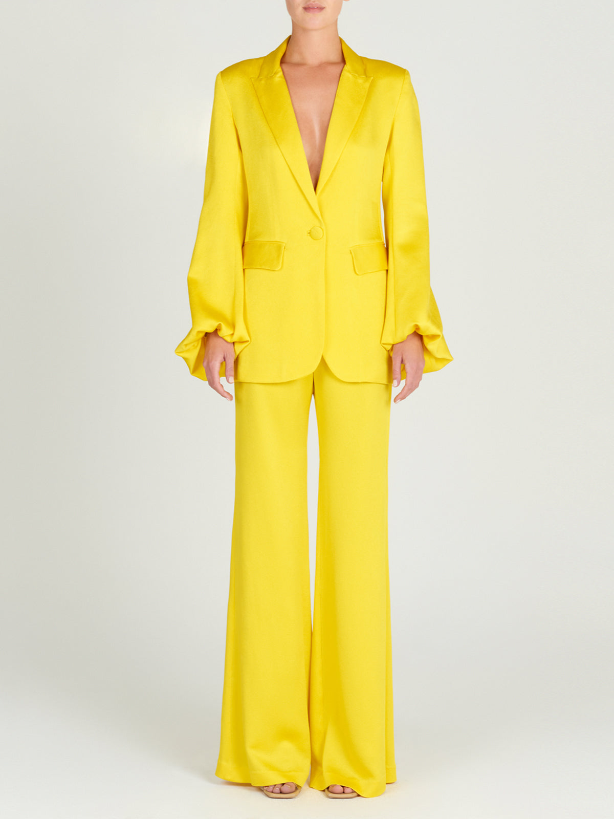 A Coco Blazer Yellow with satin ruffled sleeves.