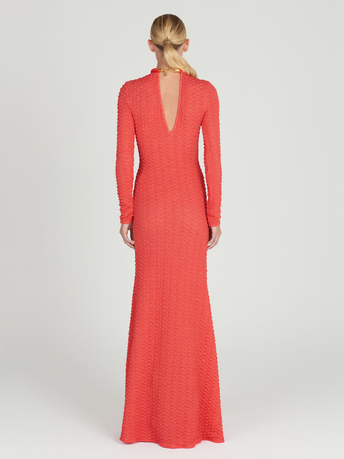 The Gabbice Dress Rouge in coral fabric is long-sleeved.