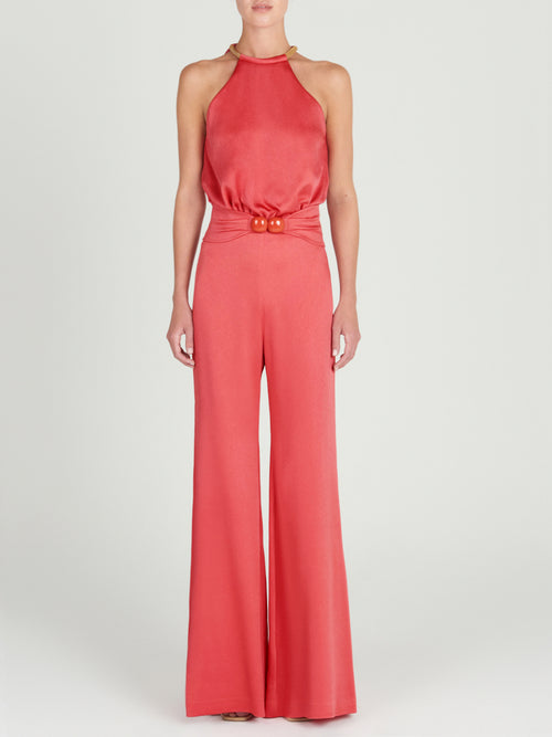 A Grosetto Jumpsuit Coral accessorized with a gold belt perfect for Resort 2024.