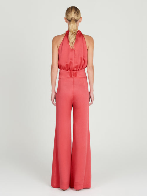 A Grosetto Jumpsuit Coral accessorized with a gold belt perfect for Resort 2024.