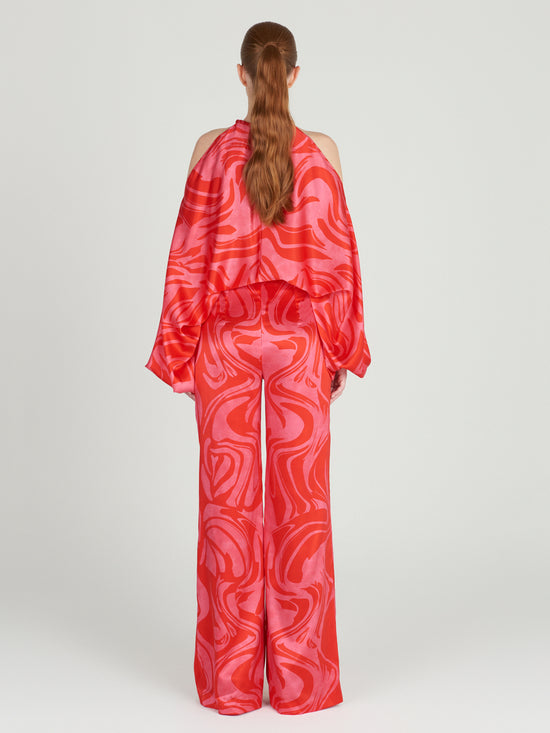 A high-waisted Andie Pant Pink Red Marble in a wide leg style.