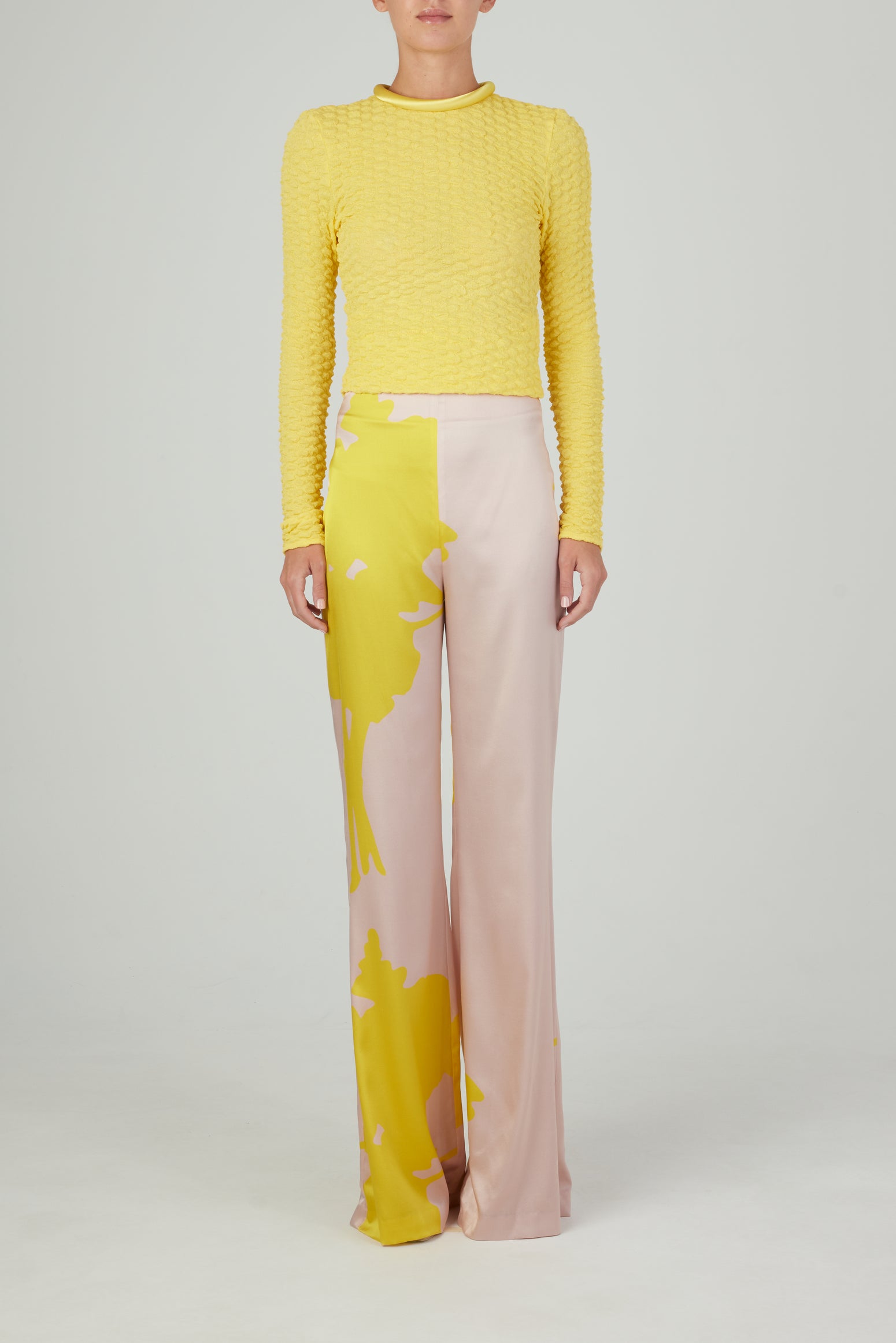 A pair of pink and yellow Andie Pant Yellow Nude Floral, wide-legged and high-waisted.