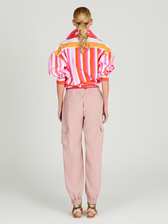 A Manrola Blouse Rouge Orange Stripes with orange and pink watercolor brushstrokes.