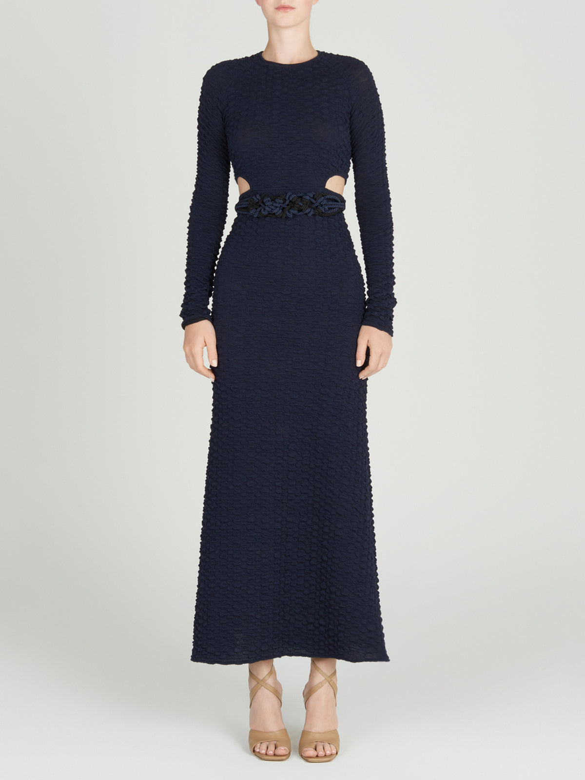 A Myriam Dress Navy with a braided belt.