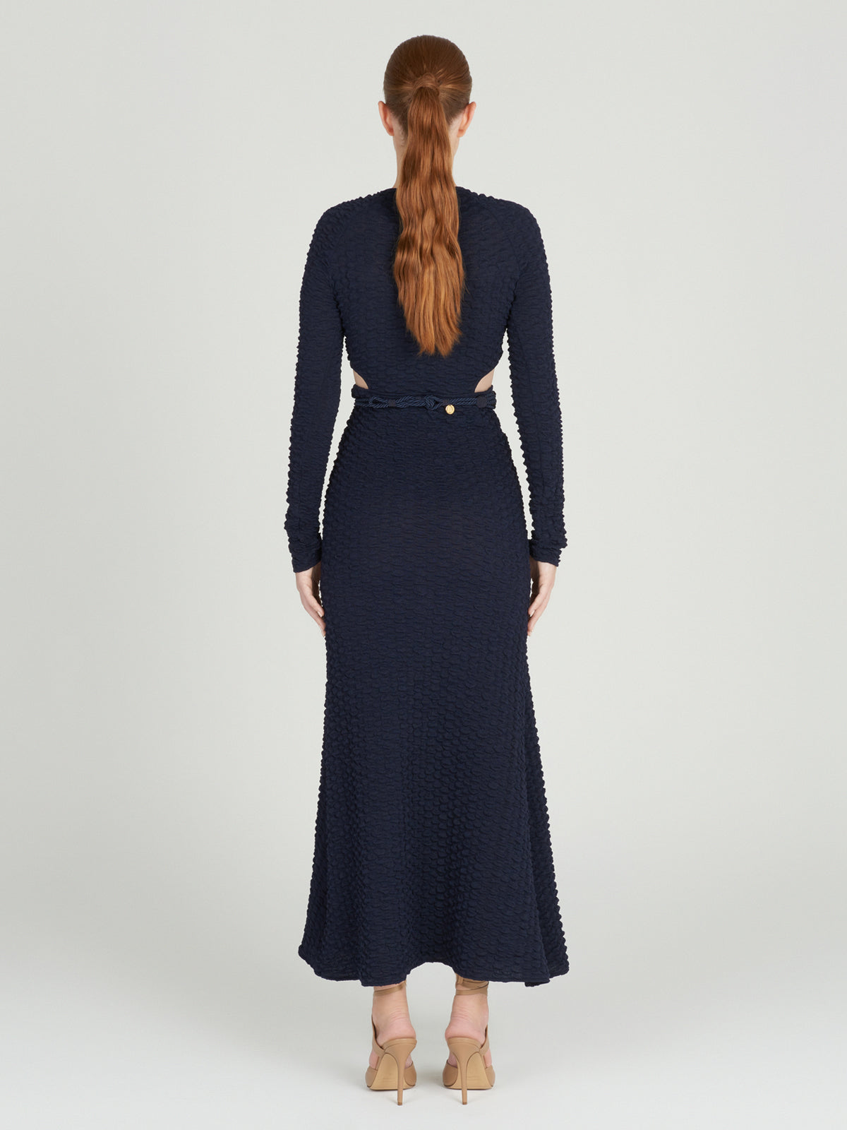 A Myriam Dress Navy with a braided belt.