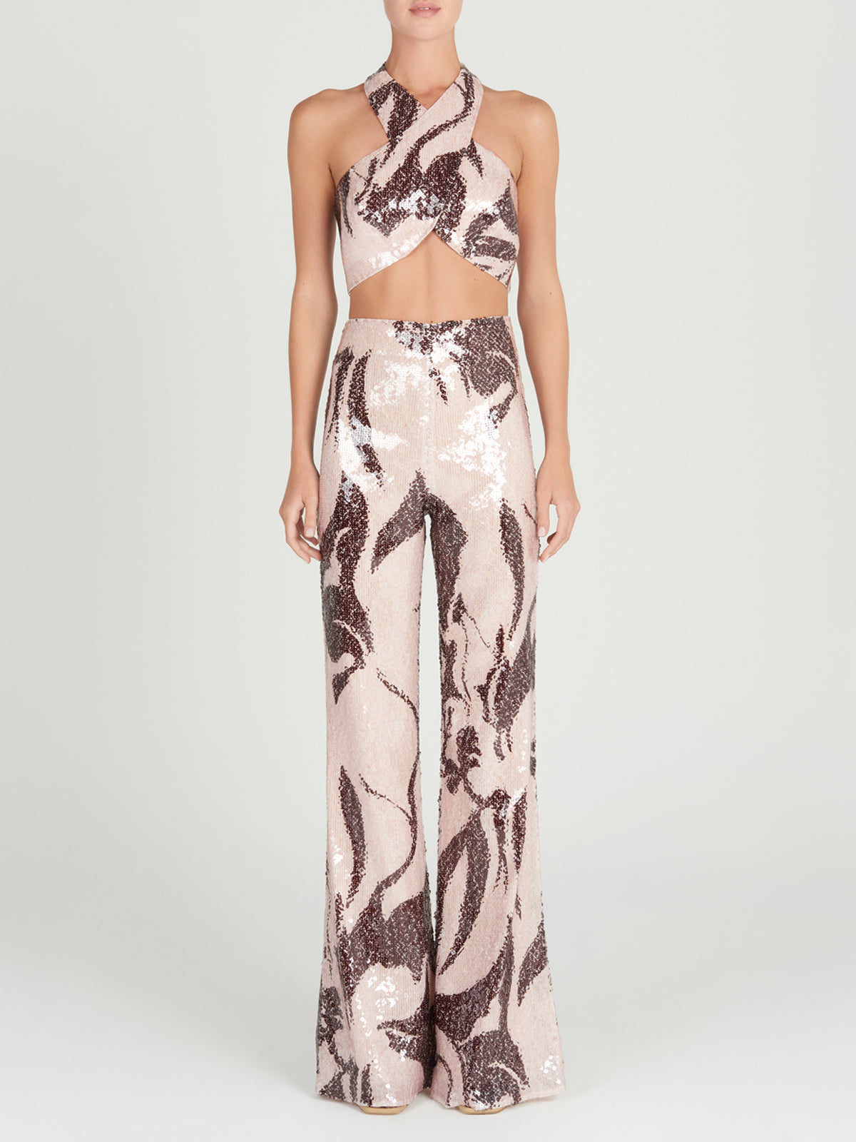 A Nahia Top Cacao Rose with a zebra print and halter neckline.