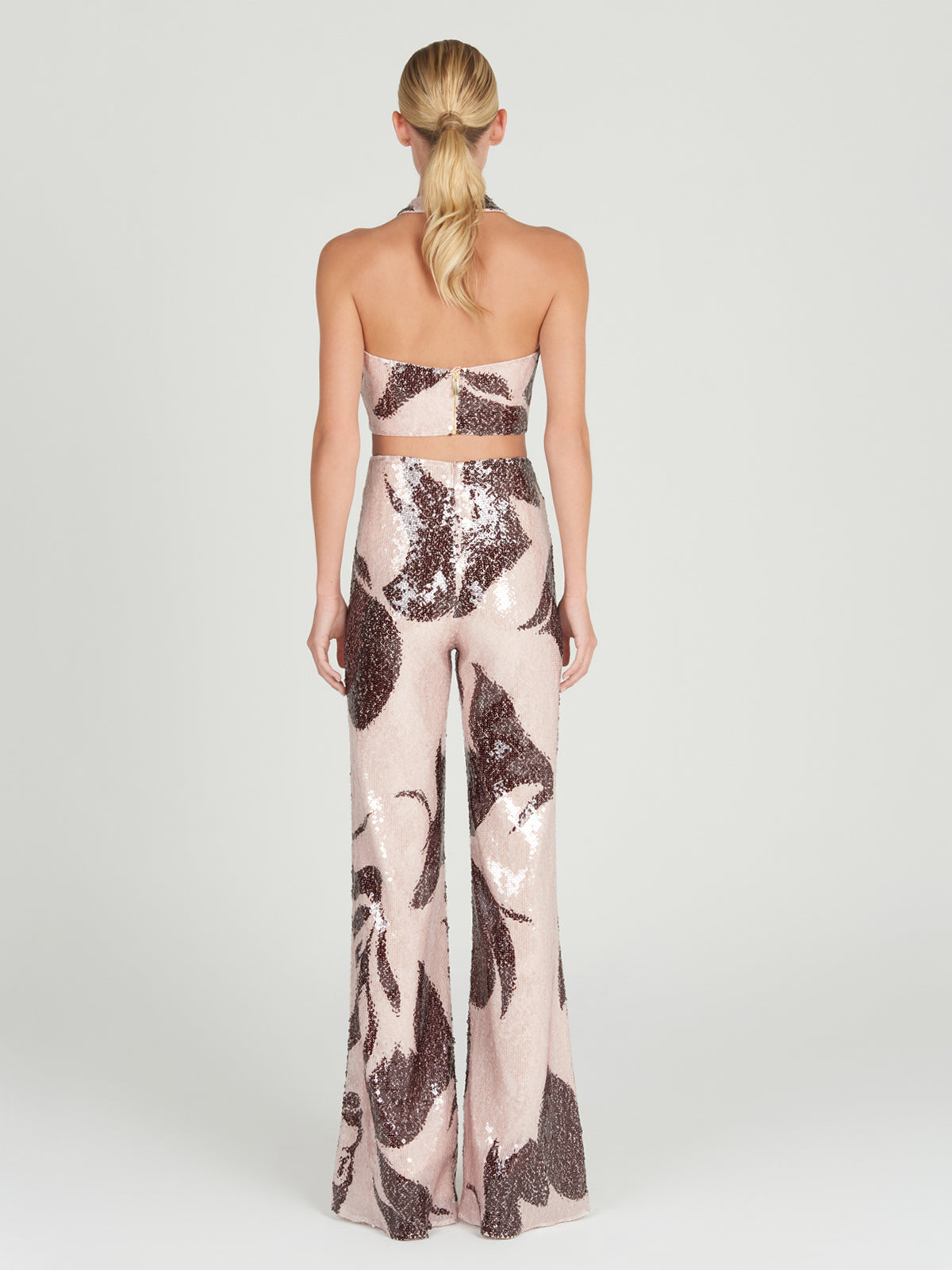 A Nahia Top Cacao Rose with a zebra print and halter neckline.