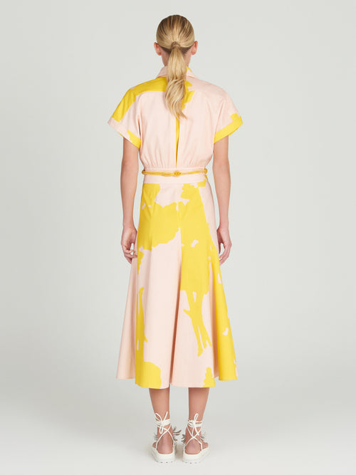 A Noor Dress Yellow Nude Floral with a belt.