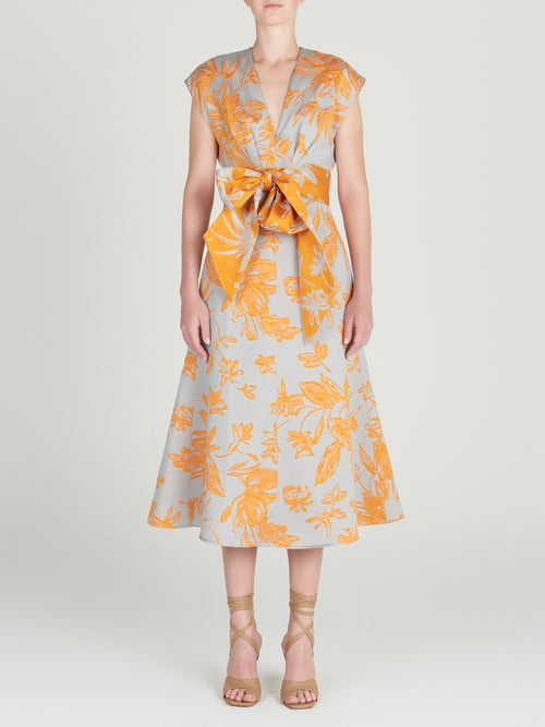 A Toledo Dress Apricot Silver with a grey floral print. Arrives in days.