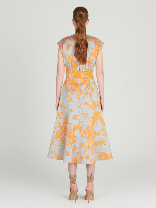 A Toledo Dress Apricot Silver with a grey floral print. Arrives in days.