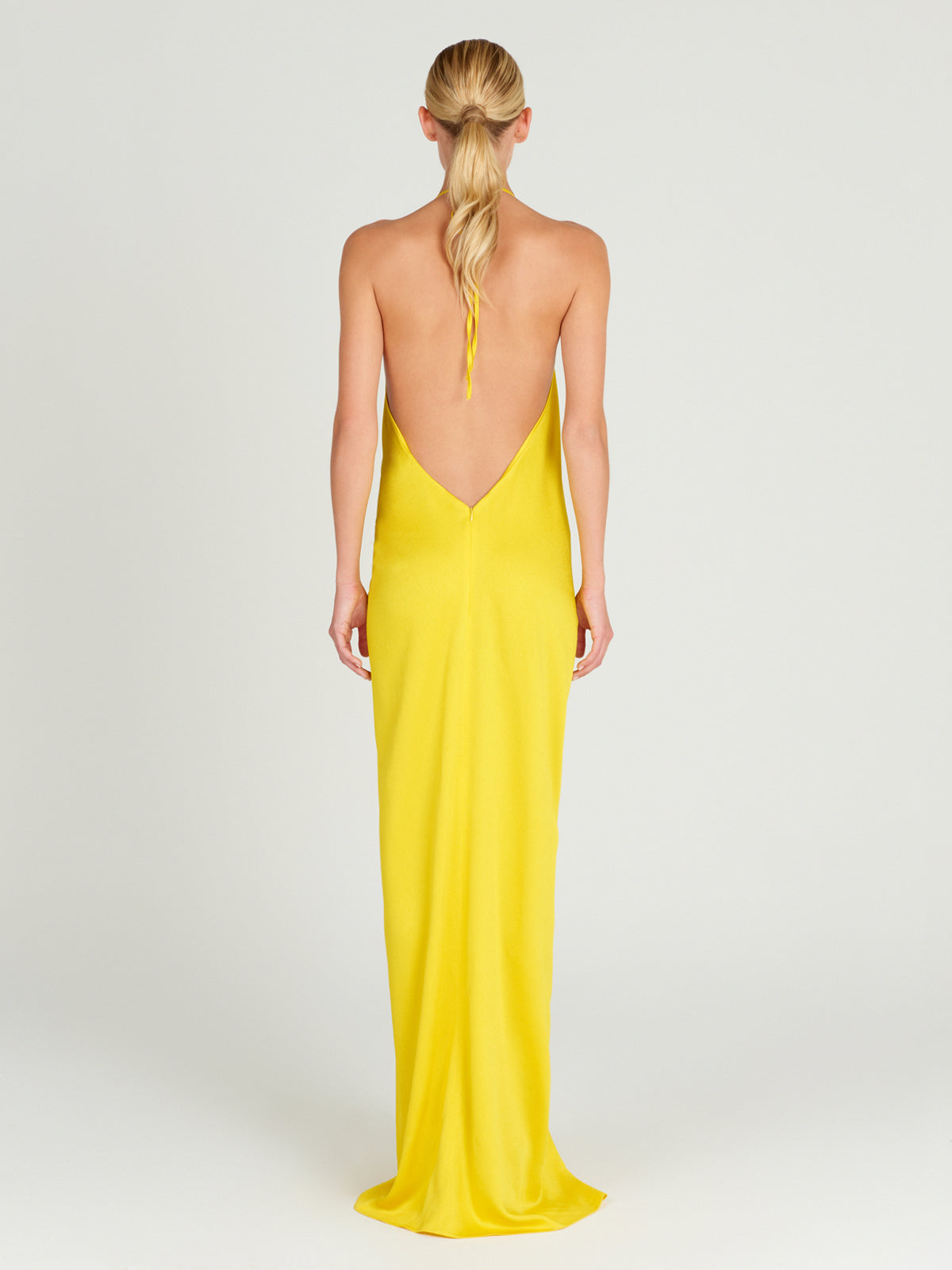 This Torgiano Dress Yellow features a halter neckline.