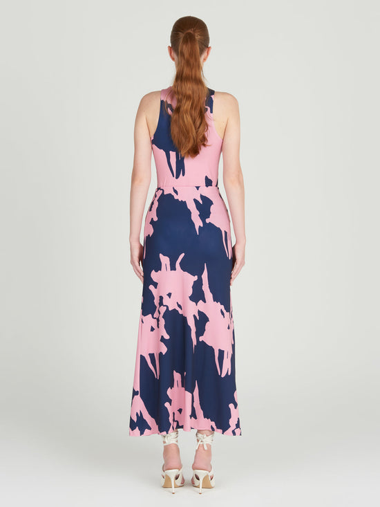 The Trieste Skirt Pink Navy showcases an A-line silhouette, highlighting a pink abstract print set against a dark blue background, displayed on a white backdrop.