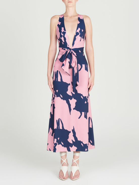 The Trieste Skirt Pink Navy showcases an A-line silhouette, highlighting a pink abstract print set against a dark blue background, displayed on a white backdrop.