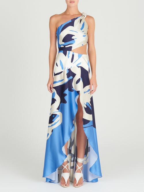 A Whitney Dress Celeste Bloom with an abstract pattern and a one-shoulder silhouette.