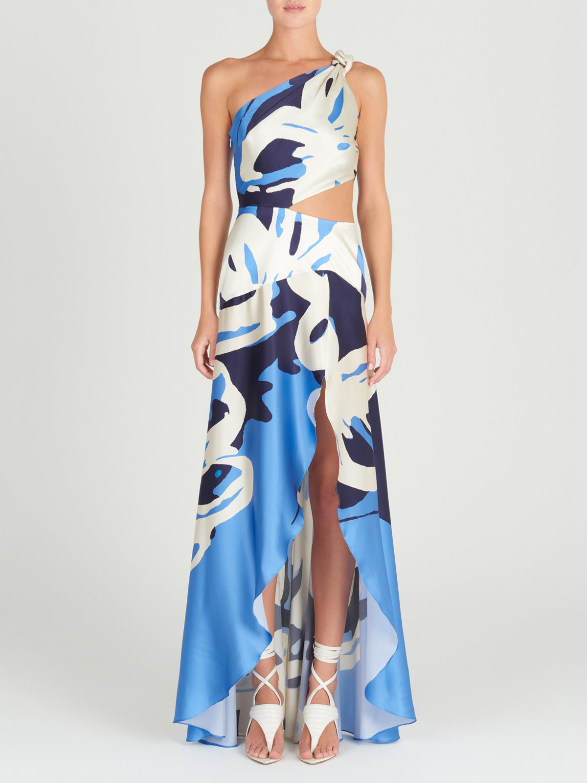 A Whitney Dress Celeste Bloom with an abstract pattern and a one-shoulder silhouette.