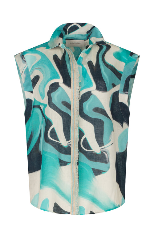 A Rina Blouse Turquoise Marble with a blue and white abstract print.