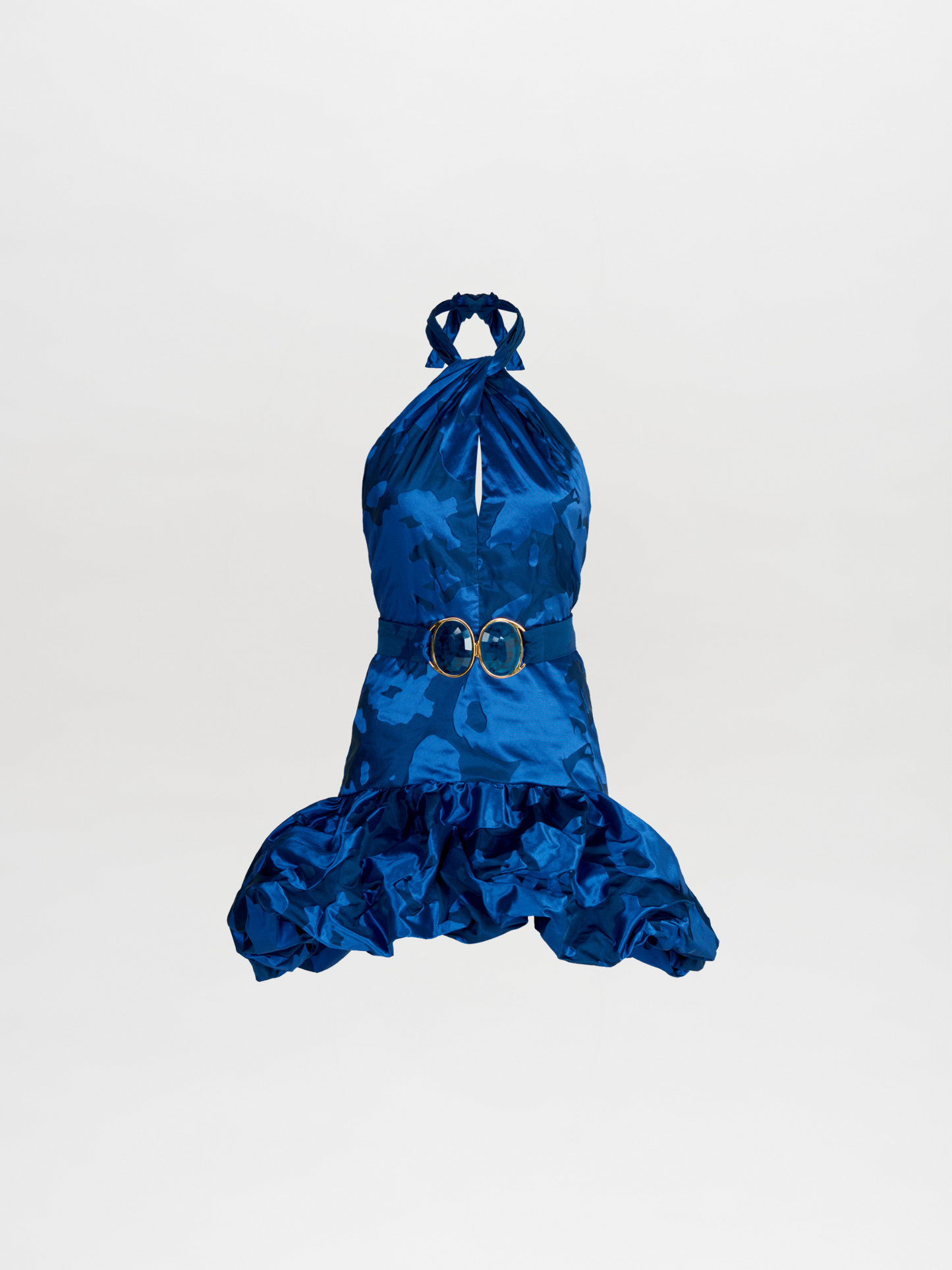 The Rea Dress Navy with a ruffled skirt and a gold belt.