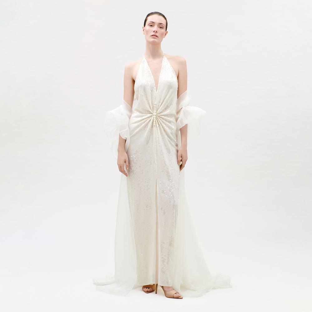 Woman wearing a white gown with a plain background
