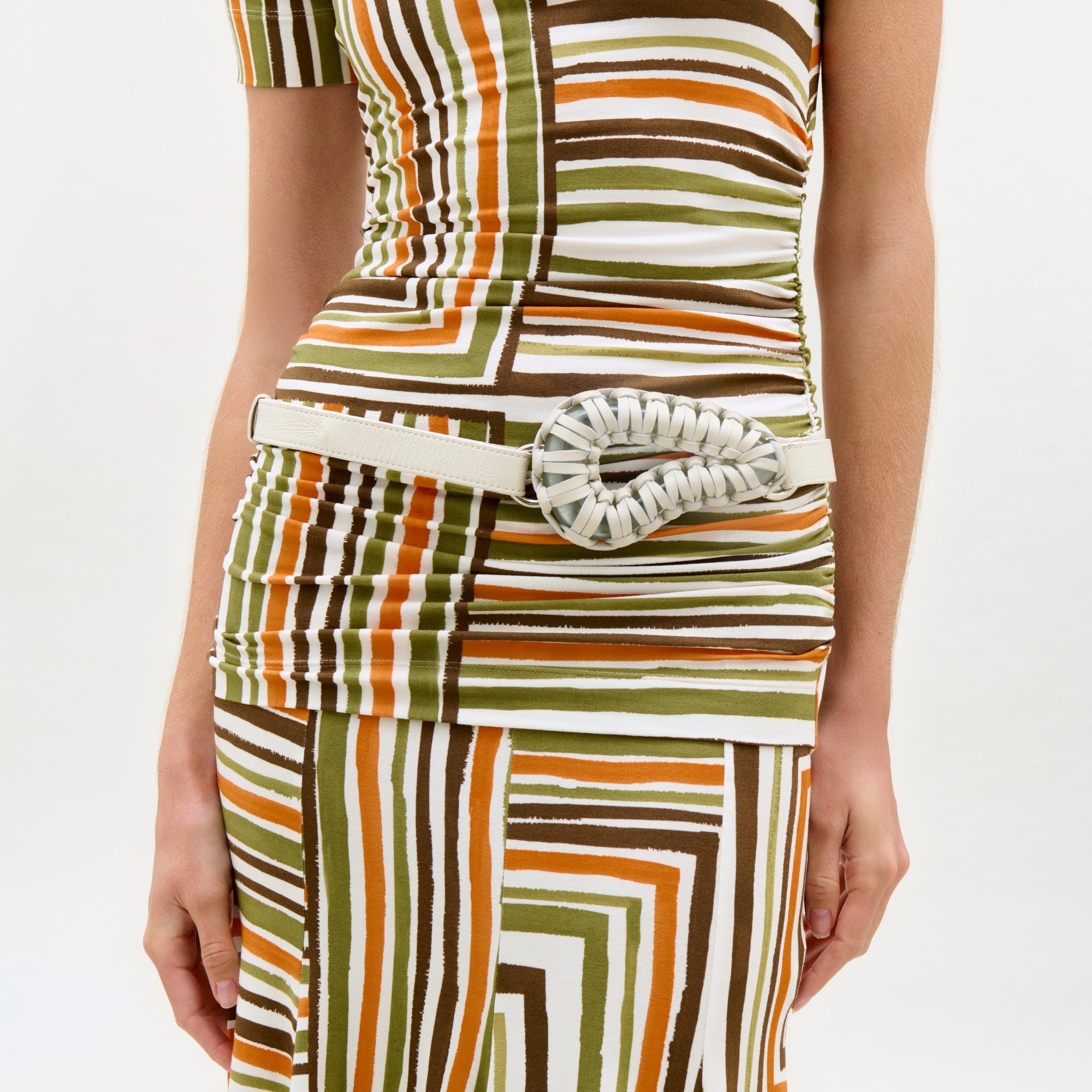 Colorful striped dress with a belt on a white background