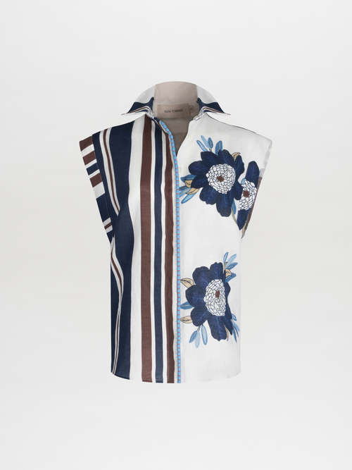 A sleeveless Rina Blouse Multi Navy Brown Floral with floral and striped patterns, featuring a pointed collar and a visible zipper on one side.