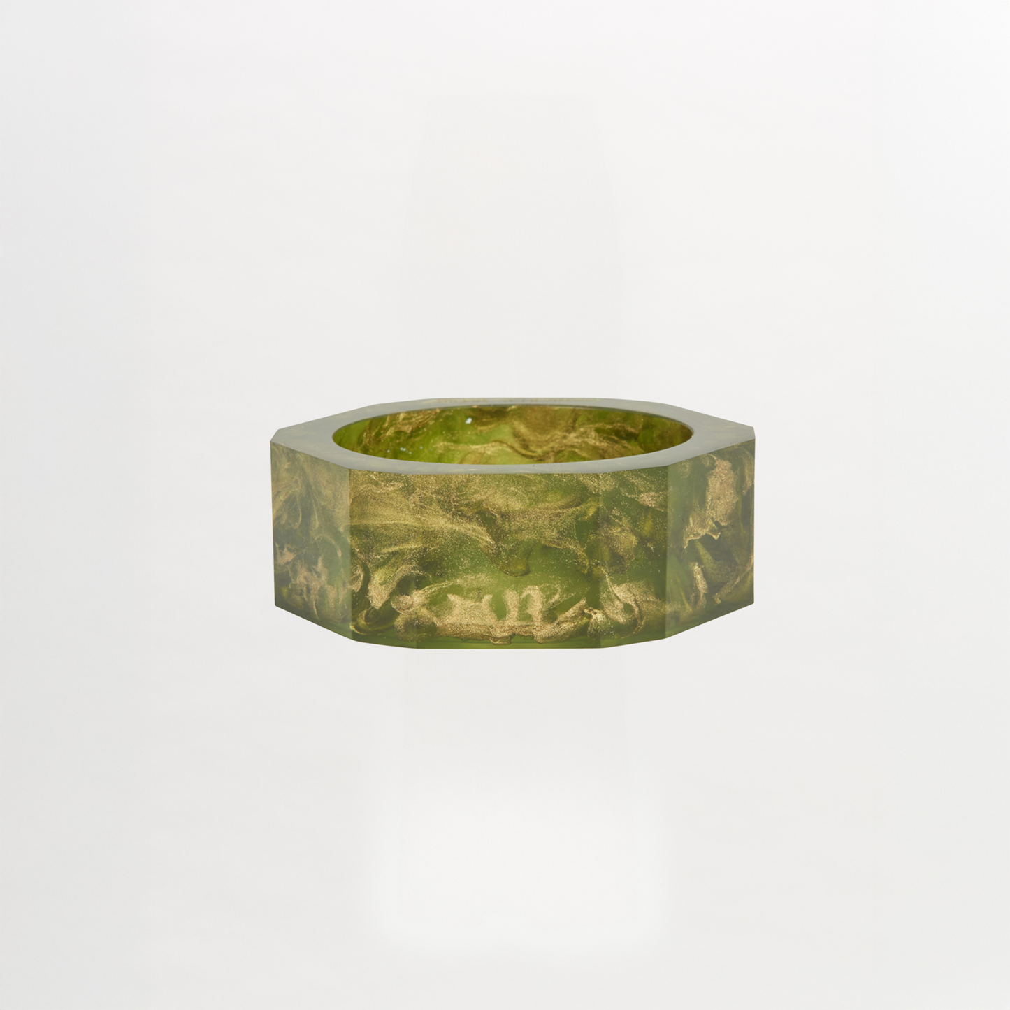 The Ruth Bangle Green, a hexagonal bowl featuring a sophisticated marbled pattern in green, elegantly rests on a plain white background. It's ready to ship just two weeks after you place your order.