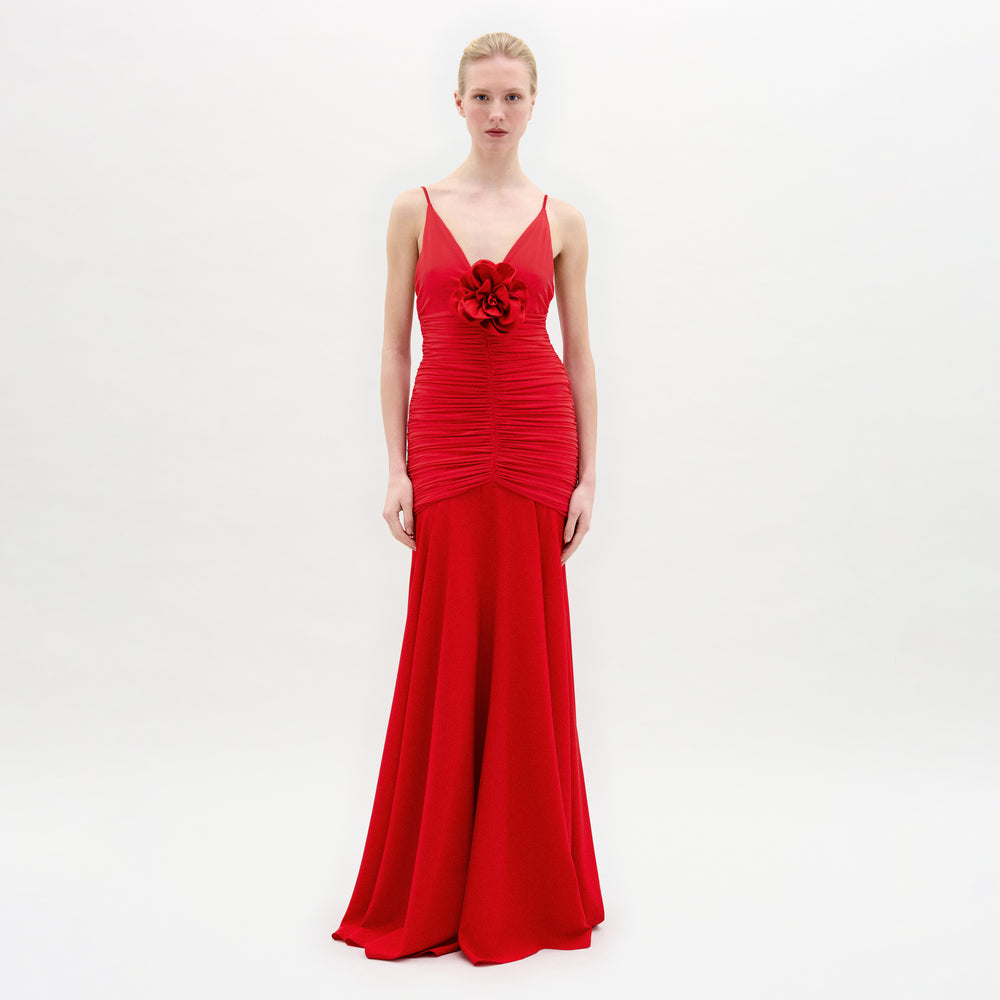 A woman wearing the Sana Dress in color Rouge on a white background.