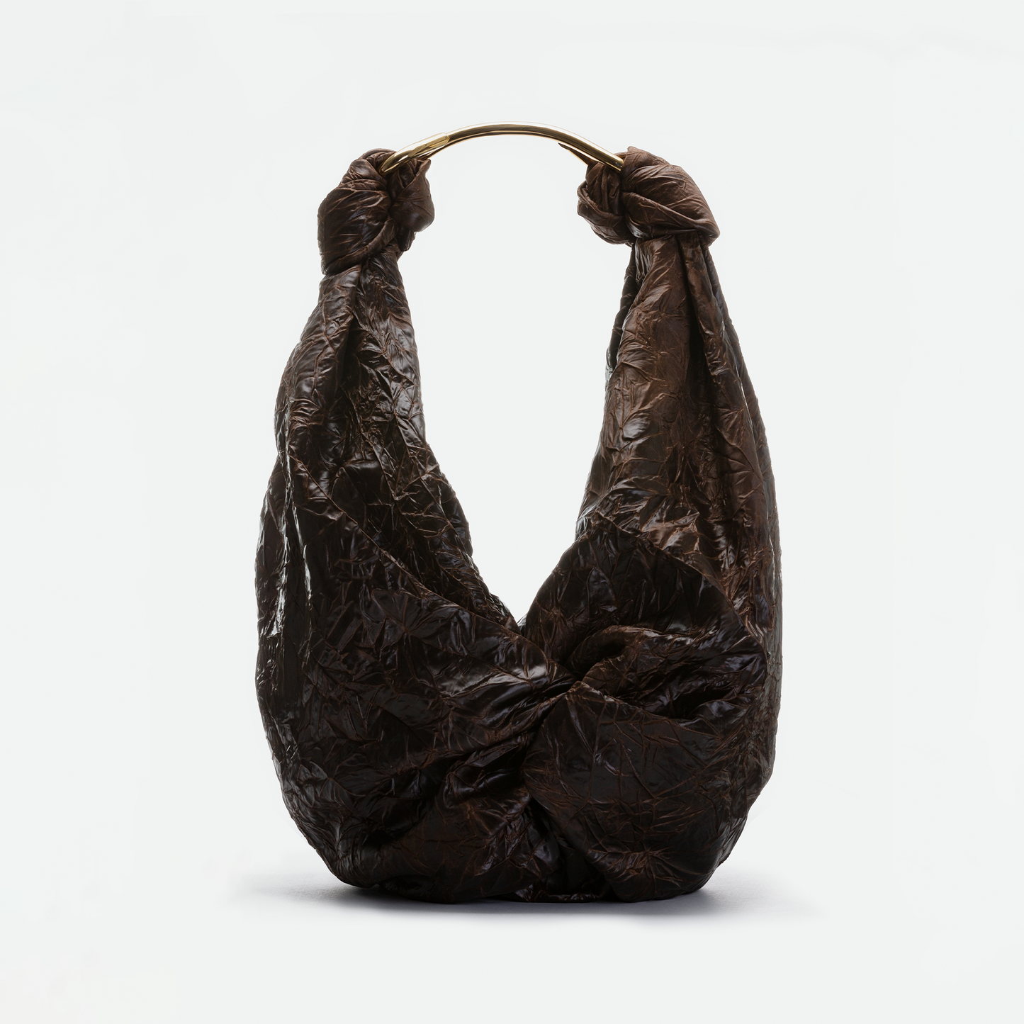 The Sofia Bag (Maxi) is a large, dark brown crinkled bag featuring a knot design and a rounded gold-toned handle, displayed against a plain light background.