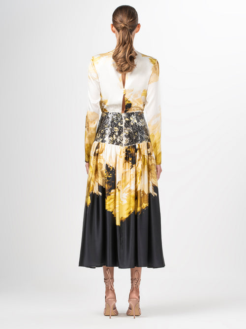 A Azalena Dress Golden Peony with a floral print in gold and black.