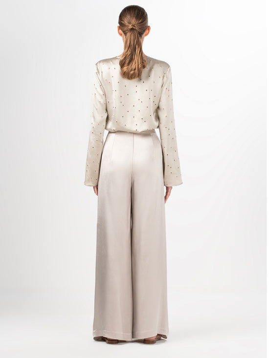 Beige high-waisted Belma Pant Ecru with a bow at the waist, featuring a wide leg silhouette.
