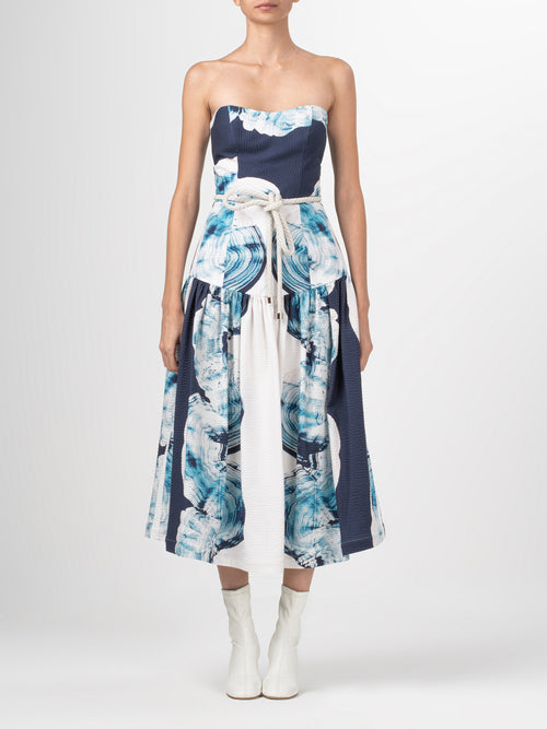 A Adelaida Dress Navy Abstract Wave with a belt.