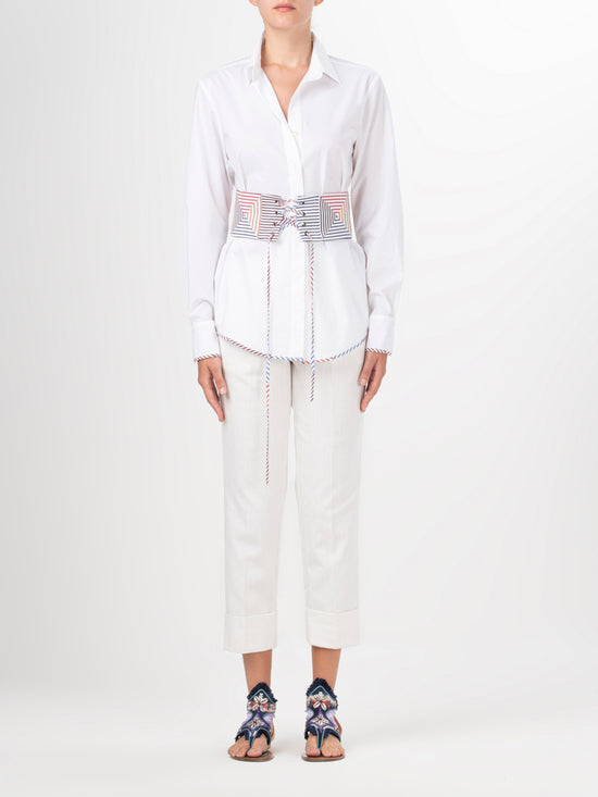 A Berenice Blouse White with a colorful belt and a fitted silhouette.