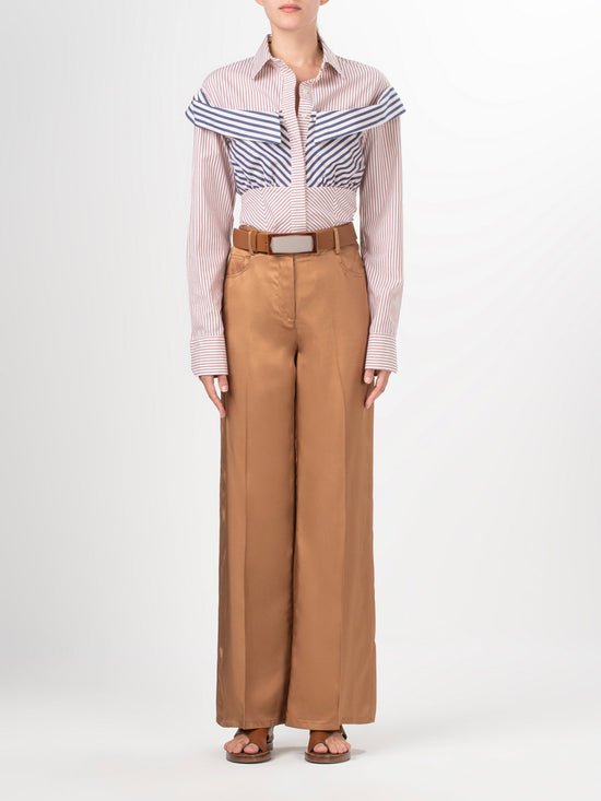 Elevate your style effortlessly with our Emine Pant Khaki, featuring a wide-leg silhouette and high-waisted design. Crafted from 100% viscose, these pants provide both comfort and elegance with their front button and zipper closure.