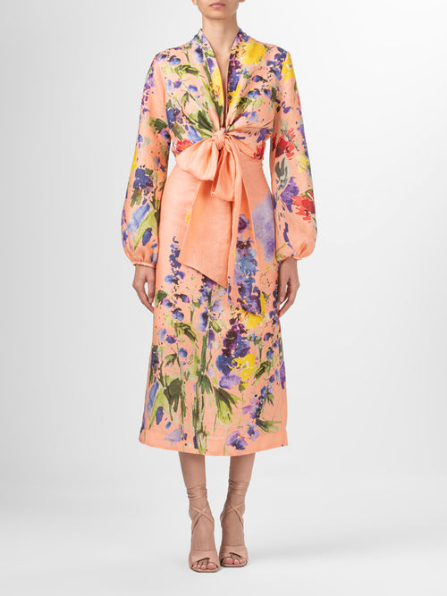 A high-waisted midi Atira Skirt Apricot Spring Garden with a multicolor floral print.