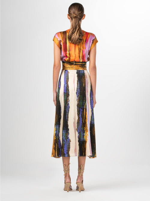 A Ivanova Dress Orange Orchid Abstract Stripes displayed on a mannequin with a V neckline.
