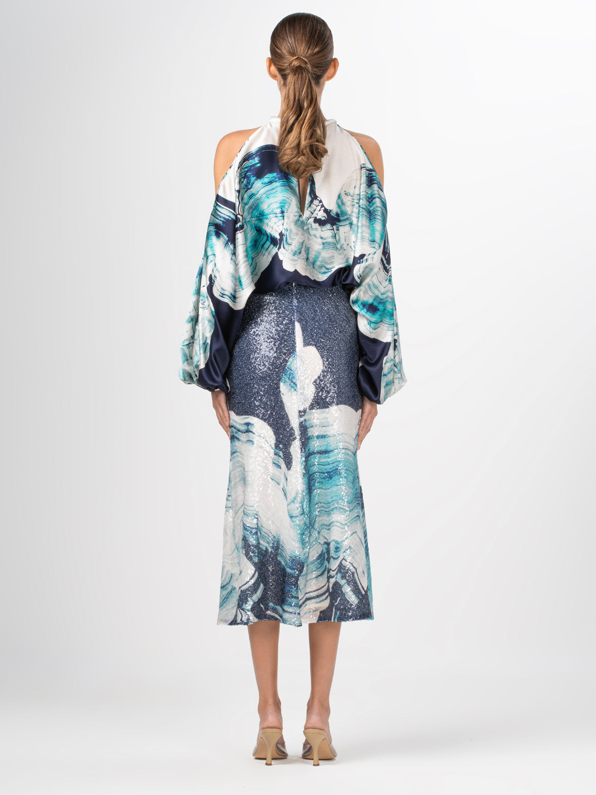 A high-waisted midi Blair Skirt Navy Abstract Wave in blue and white sequins fabric with an abstract print of waves.