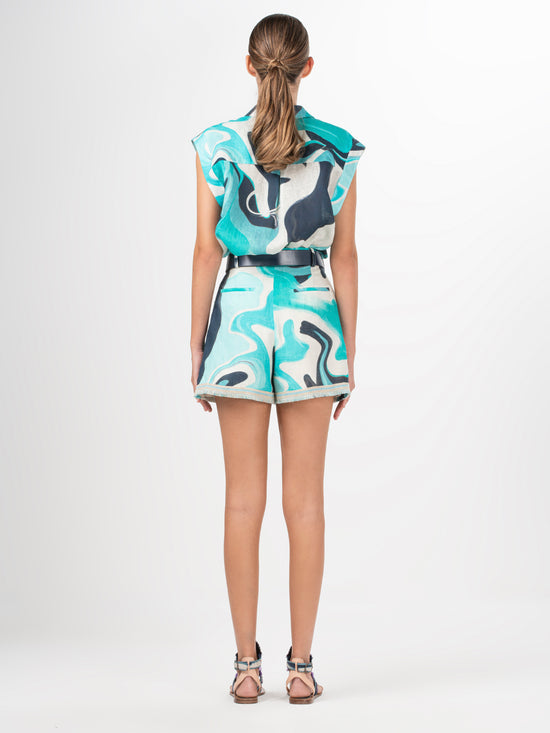 A Rina Blouse Turquoise Marble with a blue and white abstract print.