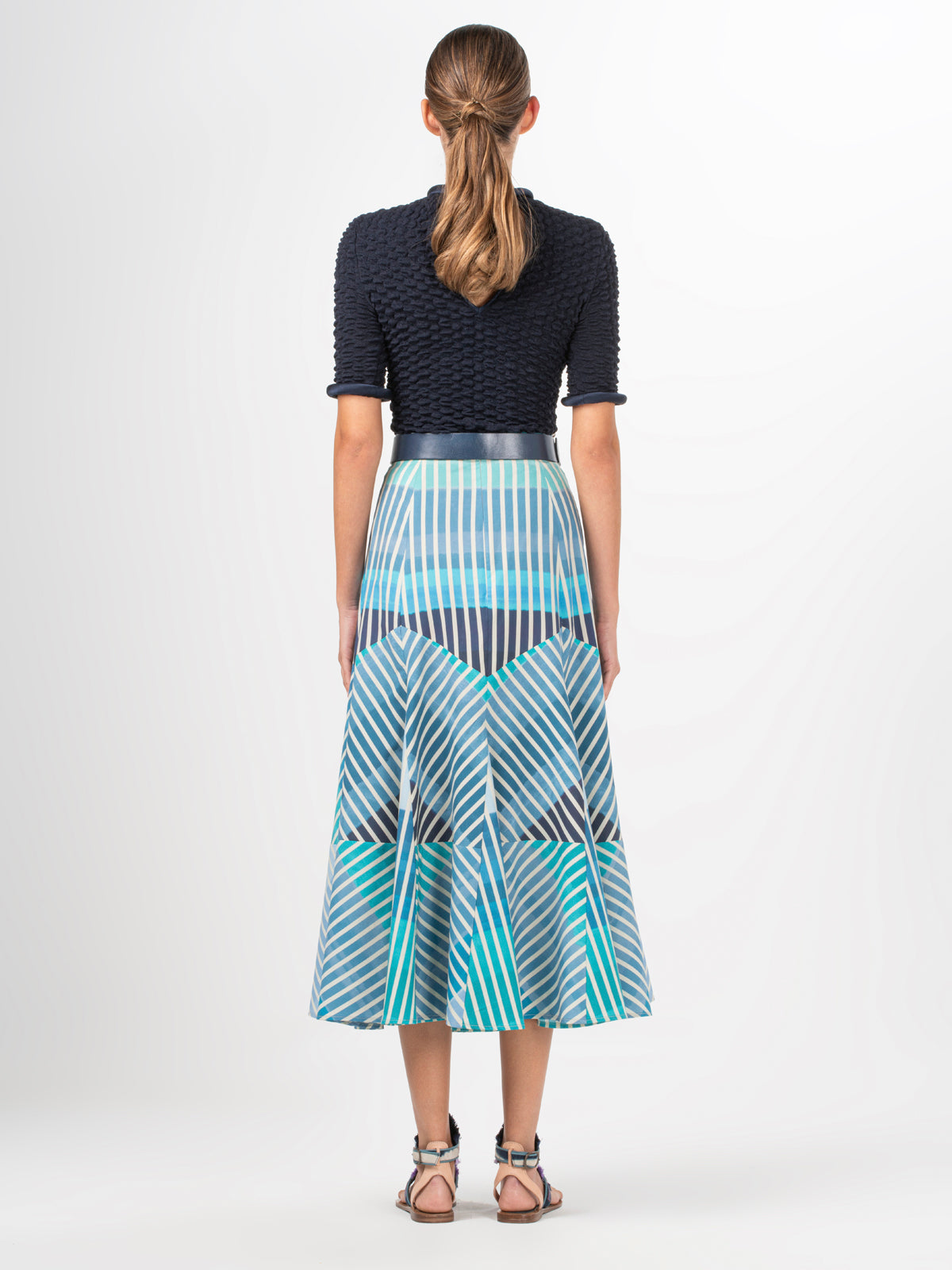 A Madaini Skirt Infinite Blue Stripes with a multicolor stripe pattern.