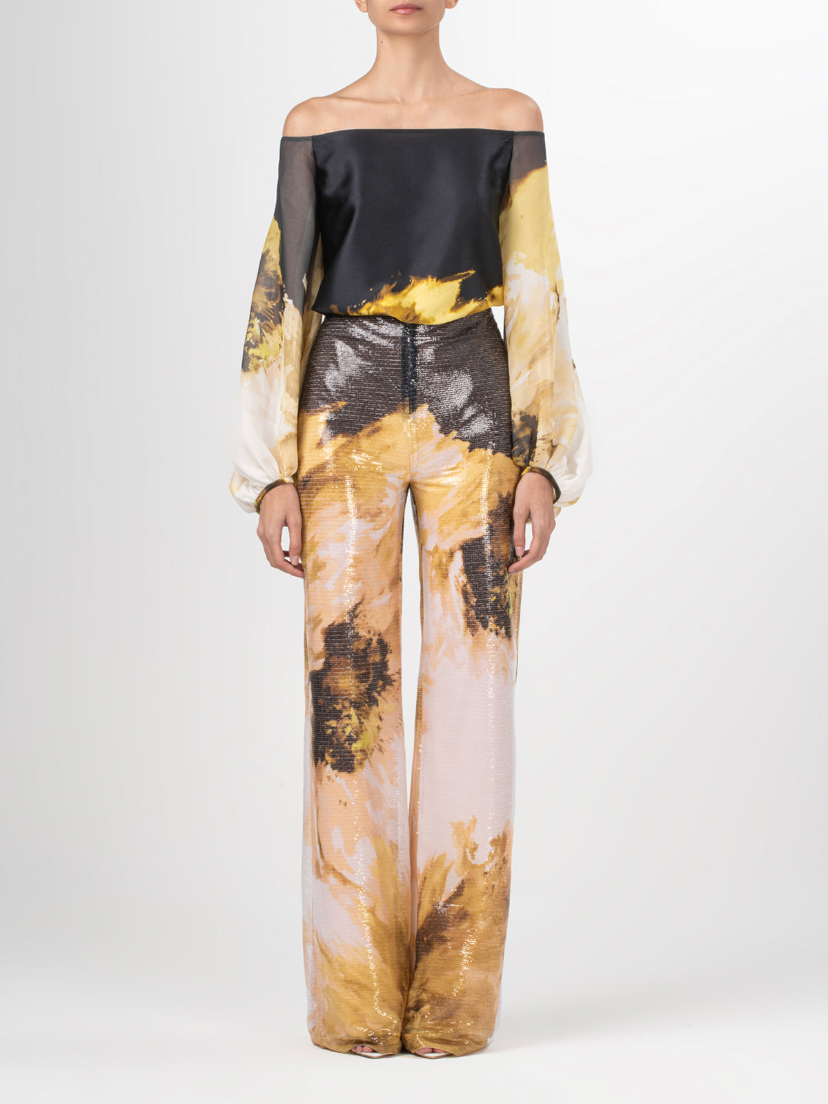 A pair of Avellino Pant Golden Peony with an abstract print.