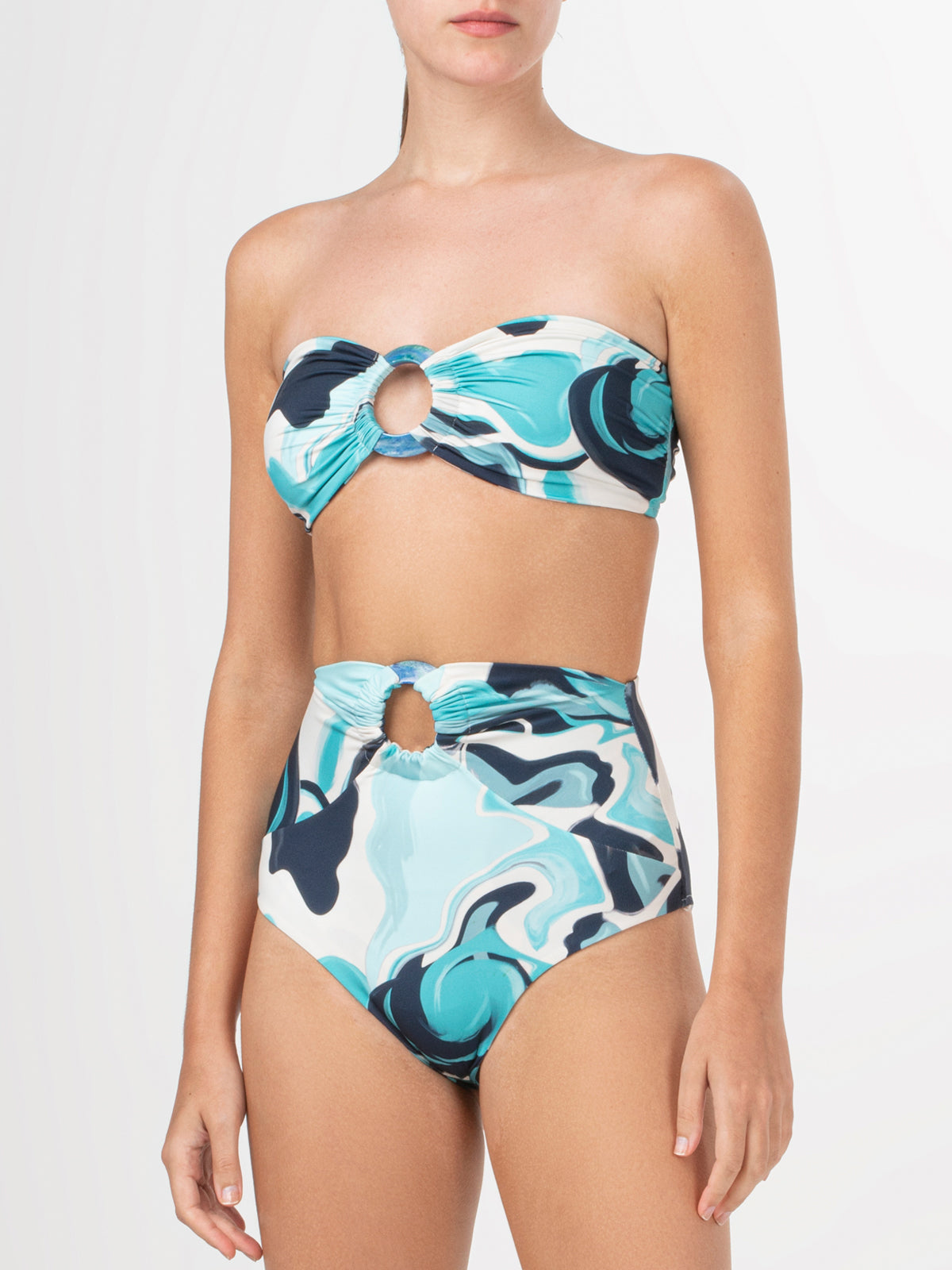 A Garlenda Top + Lecco Bikini Turquoise Marble with an abstract print and resin ring detail in blue and white.