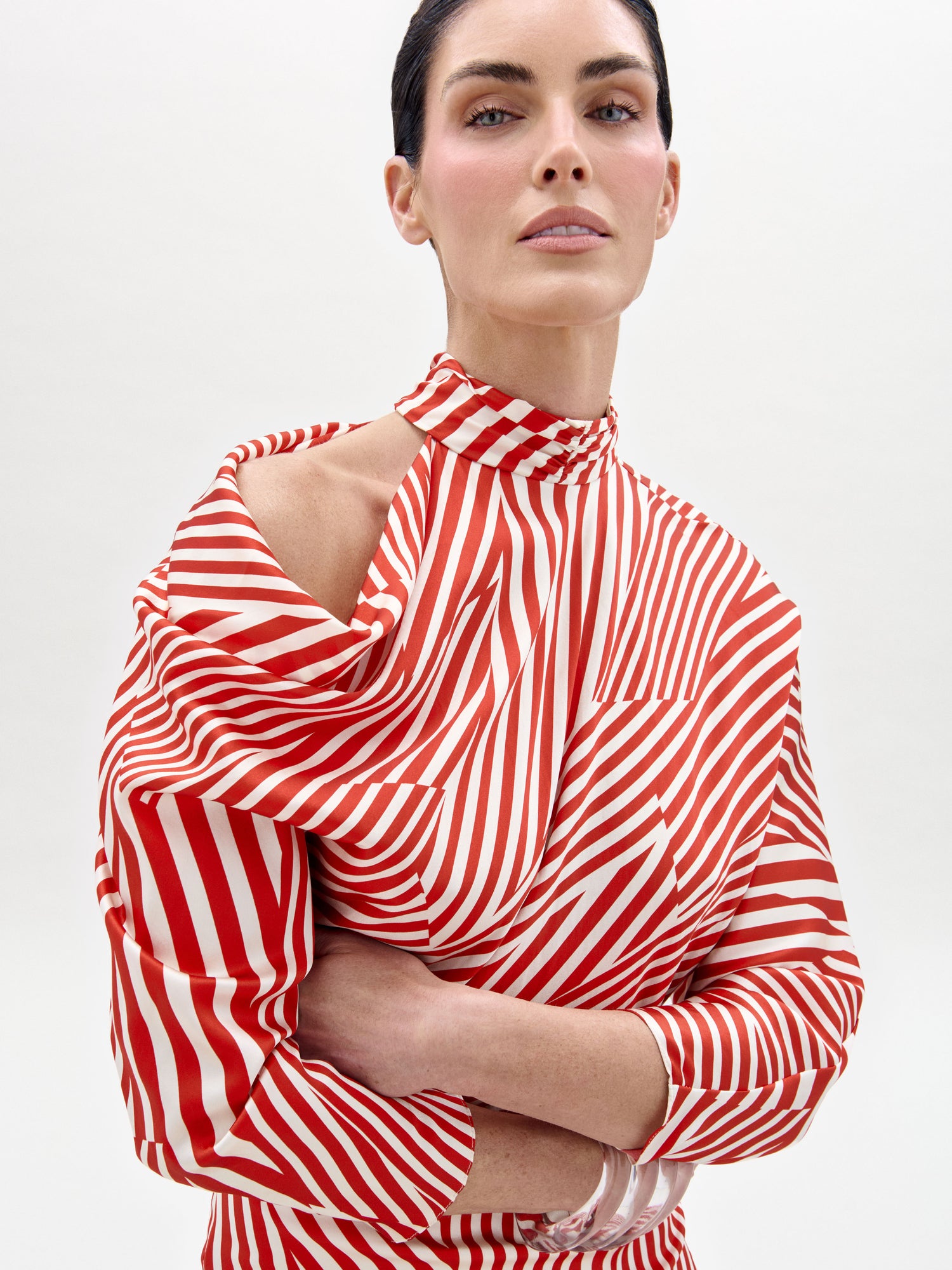 Woman wearing a red and white striped top on a plain background