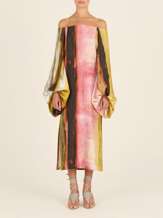 A Bernetta Tunic Canary Pink Stripes with a colorful print and bishop sleeves.