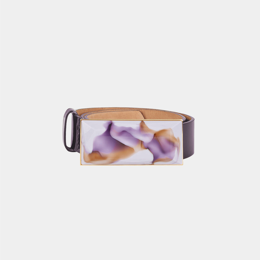 The Dora Belt Brown Purple Marble is a brown leather belt with a rectangular buckle showcasing a unique purple and white marble design, reflecting Silvia Tcherassi’s signature accessory style.