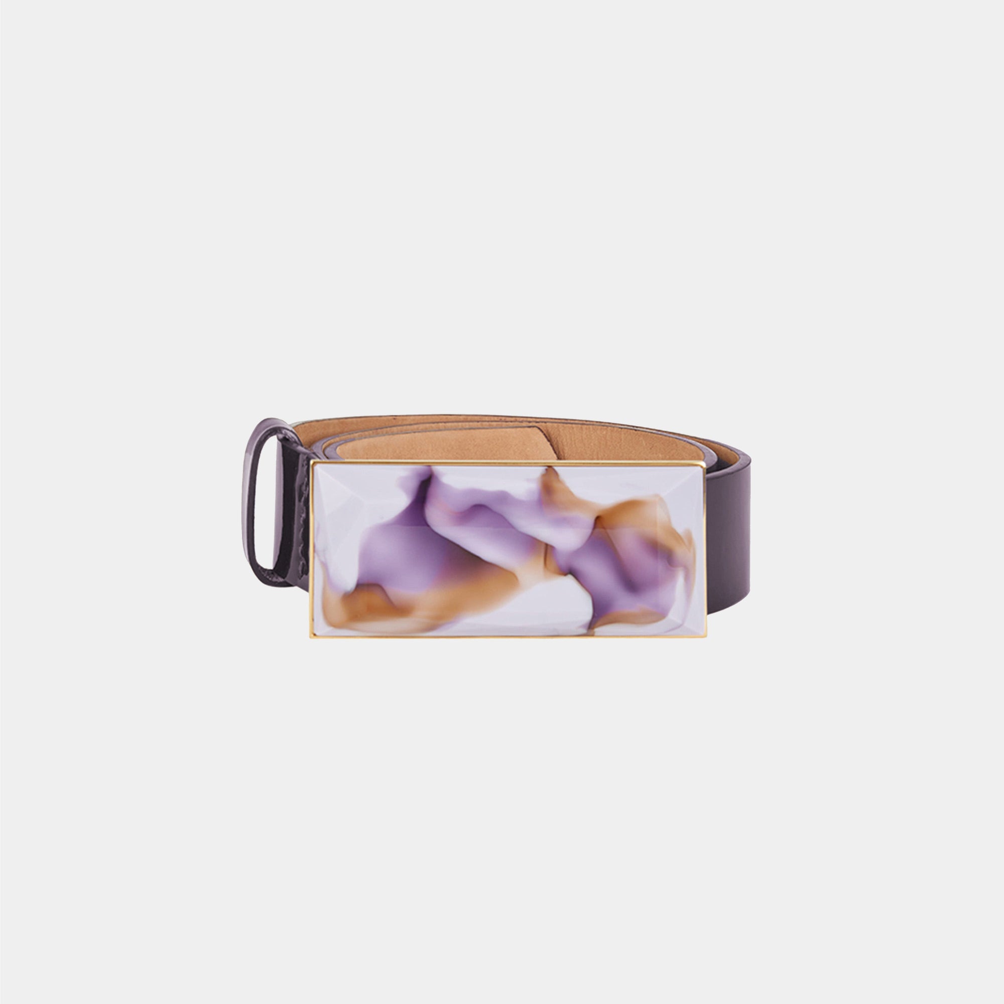 The Dora Belt Brown Purple Marble is a brown leather belt with a rectangular buckle showcasing a unique purple and white marble design, reflecting Silvia Tcherassi’s signature accessory style.