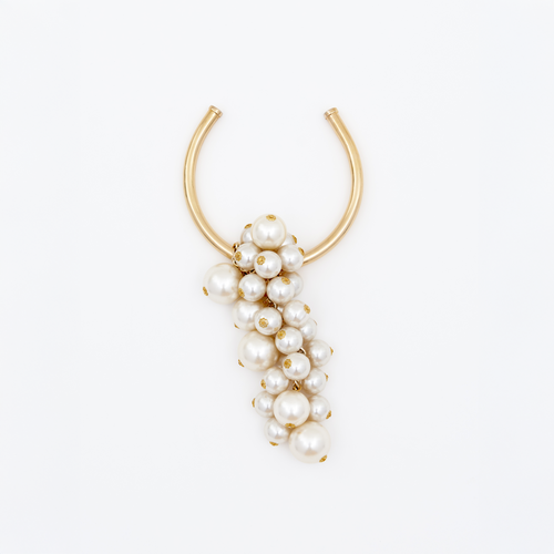 Introducing the Shania Necklace Pearl: a gold U-shaped necklace embellished with an array of white pearls in various sizes, elegantly draping in a cascading formation. Available for pre-order now to ensure delivery by February 15th.