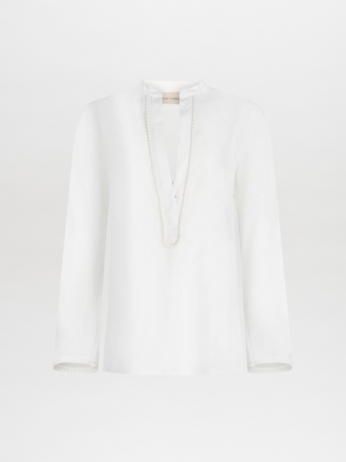 Shera Blouse White with a v-neckline and long sleeves, displayed on a plain background.