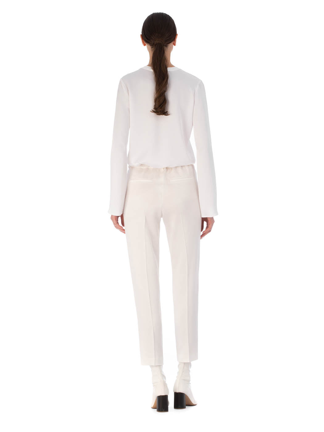 A pair of Bernie Pant White on a plain background.